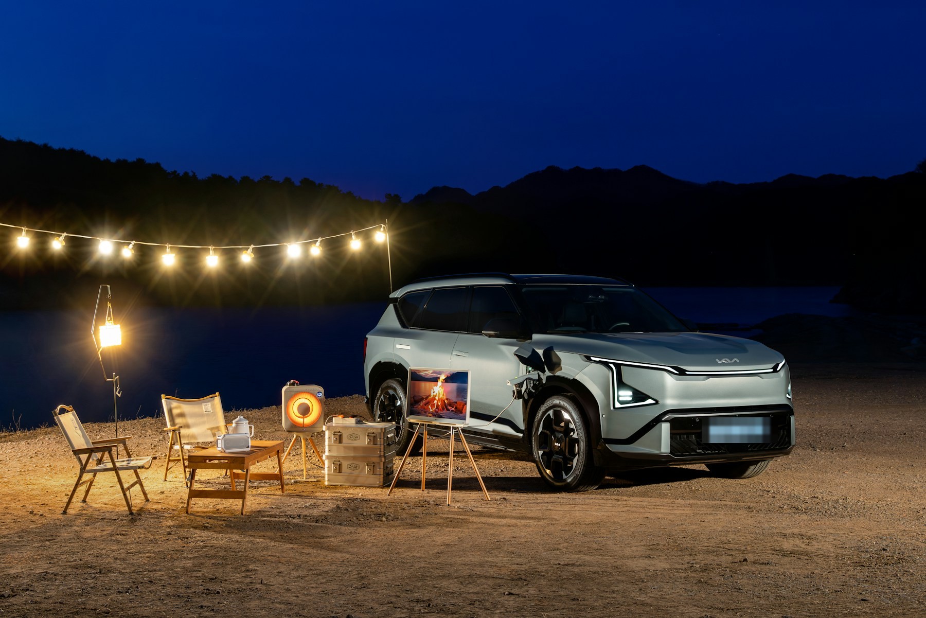 An SUV parked at a campsite at night under a string of warm lights. Illustrative photography — not a vehicle held, offered for sale, or priced by Automotive Car Brokers.
